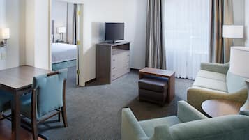 Premium bedding, desk, laptop workspace, blackout drapes