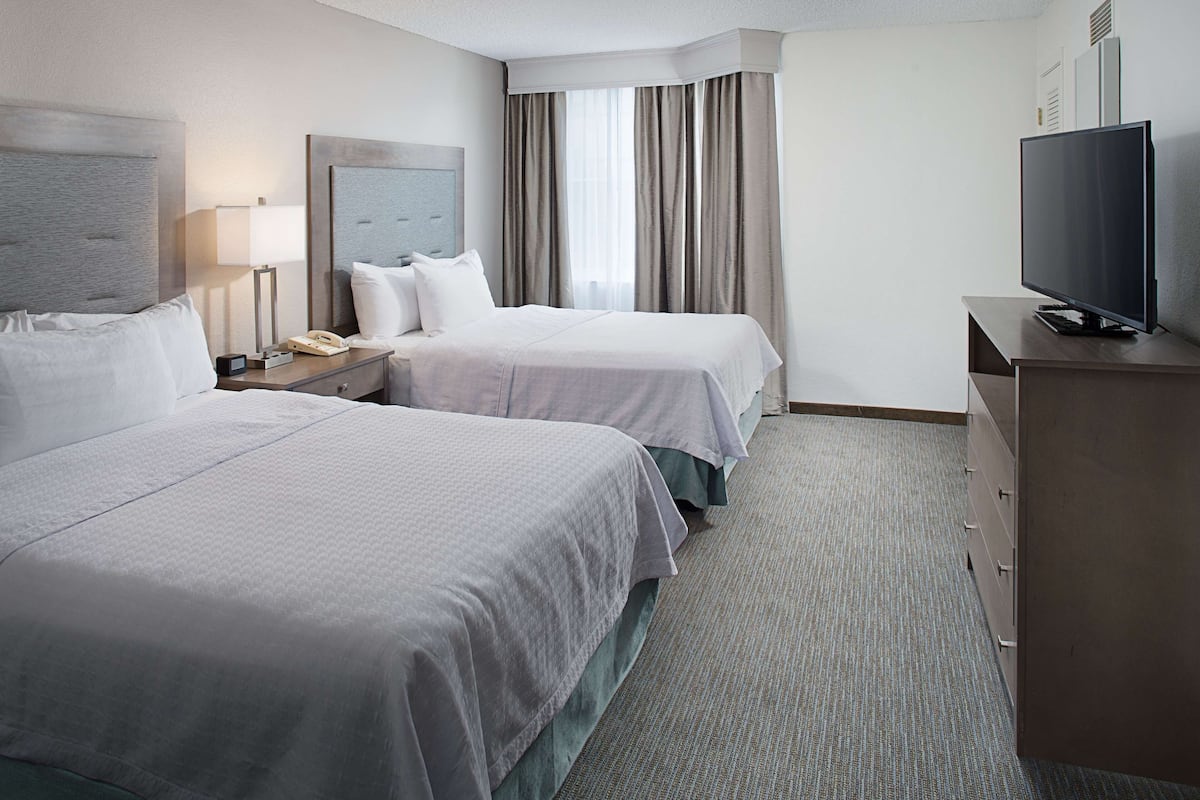 Premium bedding, desk, laptop workspace, blackout curtains