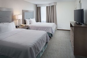 Premium bedding, desk, laptop workspace, blackout drapes