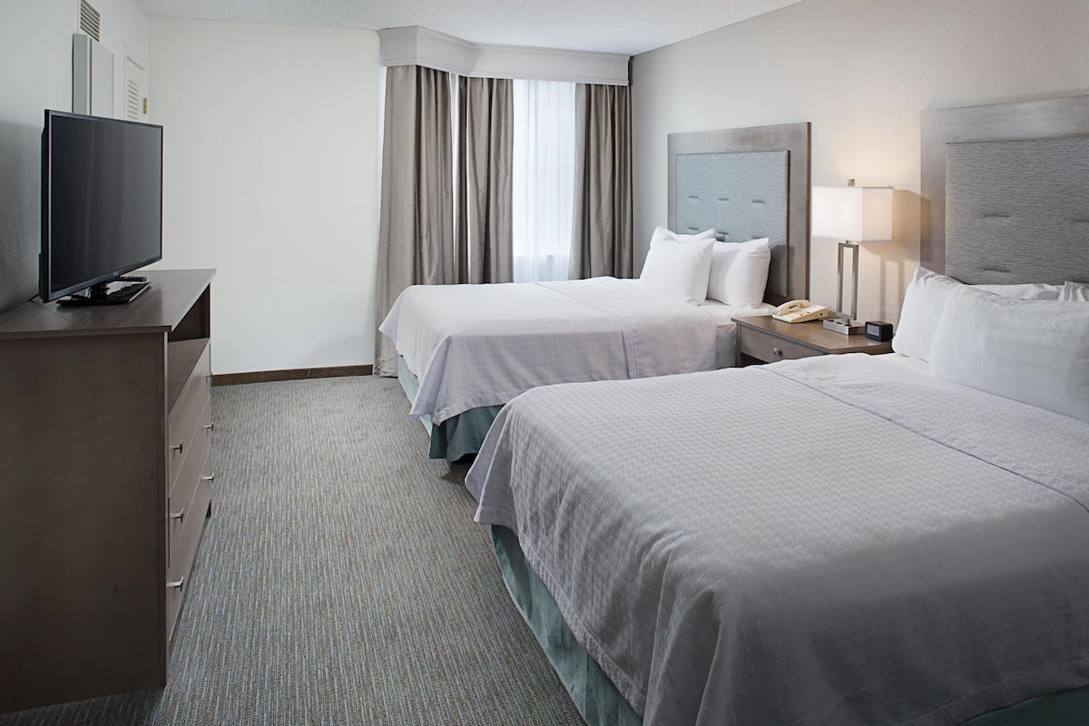 Premium bedding, desk, laptop workspace, blackout drapes