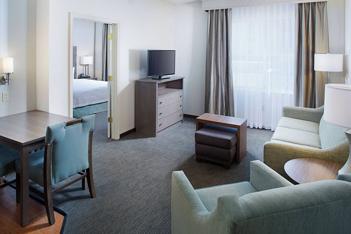 Premium bedding, desk, laptop workspace, blackout curtains