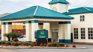 A hotel entrance with a green roof, a prominent 'Enter' sign, and a small tower-like structure.