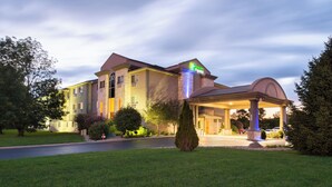 A hotel with a prominent entrance, a covered patio area, and a well-maintained lawn. - Holiday Inn Express & Suites Bucyrus by IHG (Bucyrus)