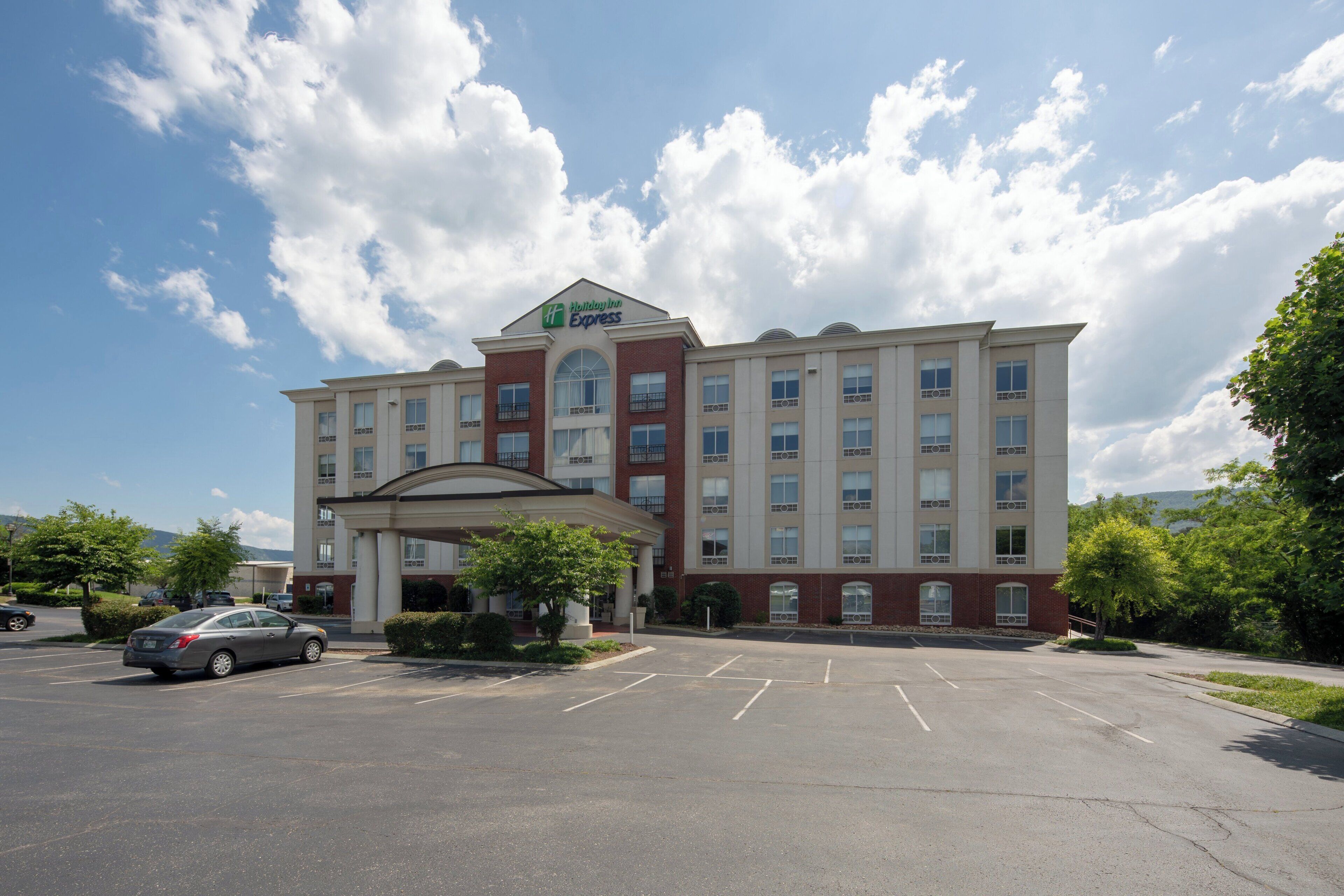 A Holiday Inn Express hotel with a brick facade, multiple windows, and a parking lot.