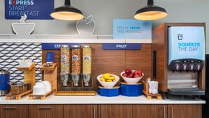 A breakfast bar with a coffee machine, fruit bowls, and cereal dispensers. - Holiday Inn Express Hotel & Suites Chattanooga-Lookout Mtn by IHG (Chattanooga)