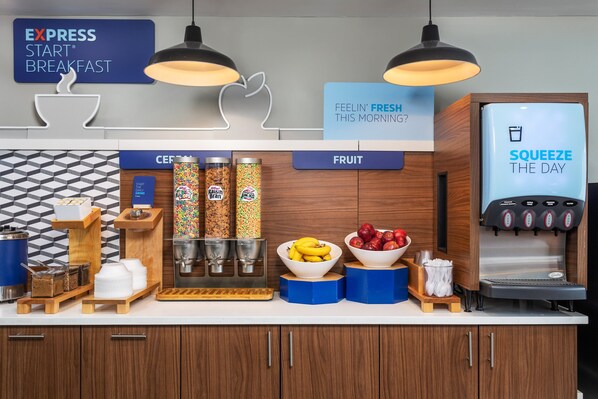 A breakfast bar with a coffee machine, fruit bowls, and cereal dispensers. - Holiday Inn Express Hotel & Suites Chattanooga-Lookout Mtn by IHG (Chattanooga)