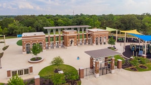 A brick building with arched doorways and a covered area with a roof.