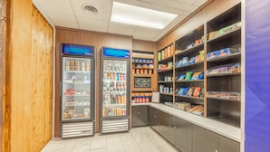 A self-service snack area with refrigerated and non-refrigerated shelves stocked with various food items.