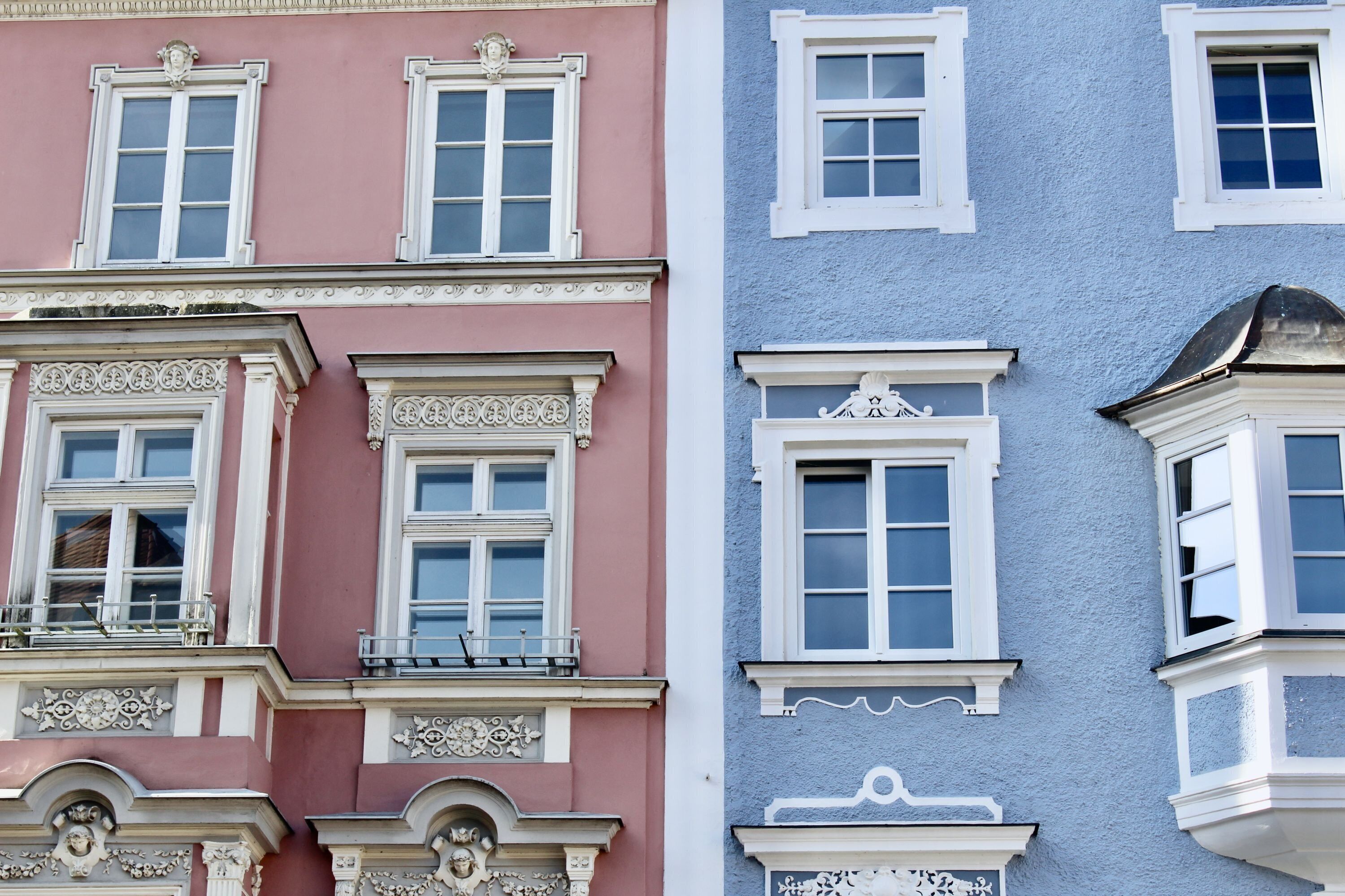 A row of buildings with distinct architectural styles and window designs.