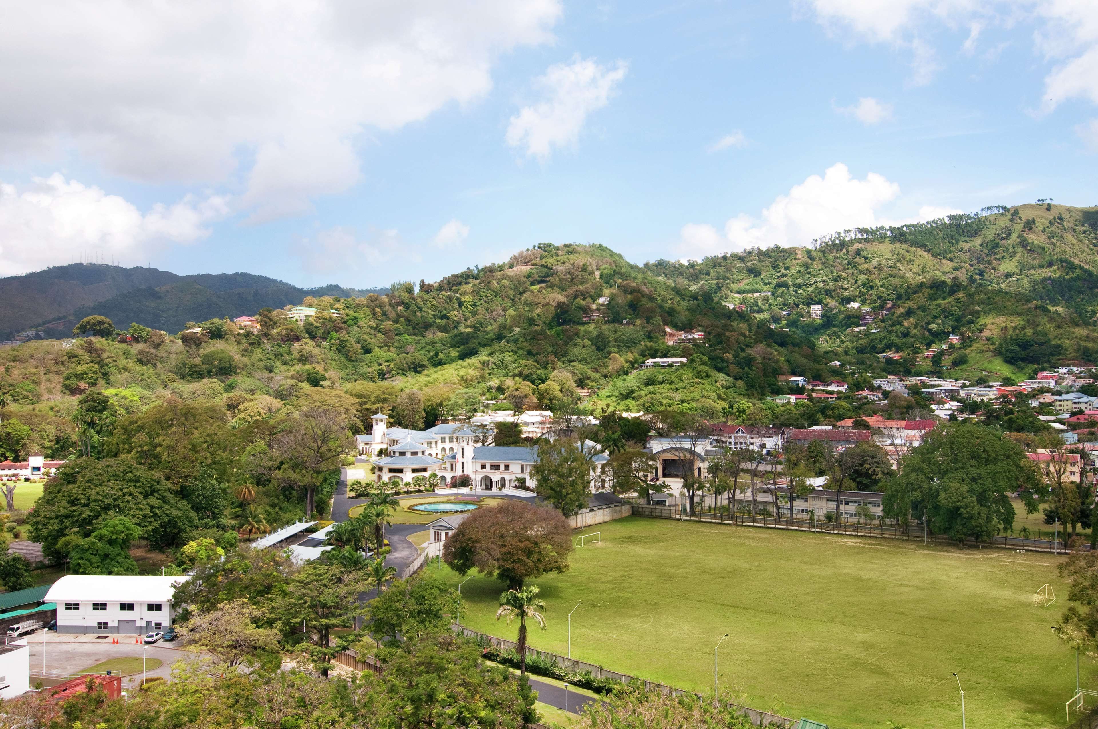 A large estate with a spacious lawn, a swimming pool, and a tennis court.