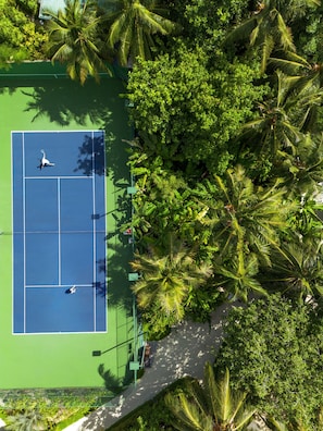 An aerial view of a tennis court surrounded by dense tropical foliage. - Conrad Maldives Rangali Island (Rangalifinolhu)