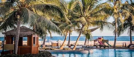 On the beach, white sand, beach umbrellas, beach towels