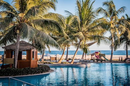 On the beach, white sand, beach umbrellas, beach towels