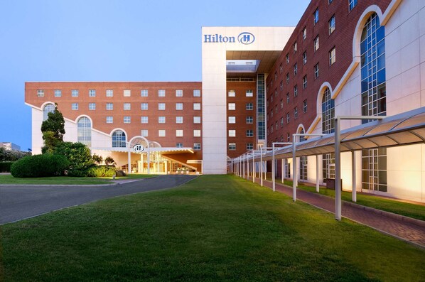 Experience the Hilton's elegant architecture, featuring a symmetrical facade and large windows.