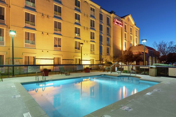 Relax by the hotel's rectangular pool surrounded by a paved deck.