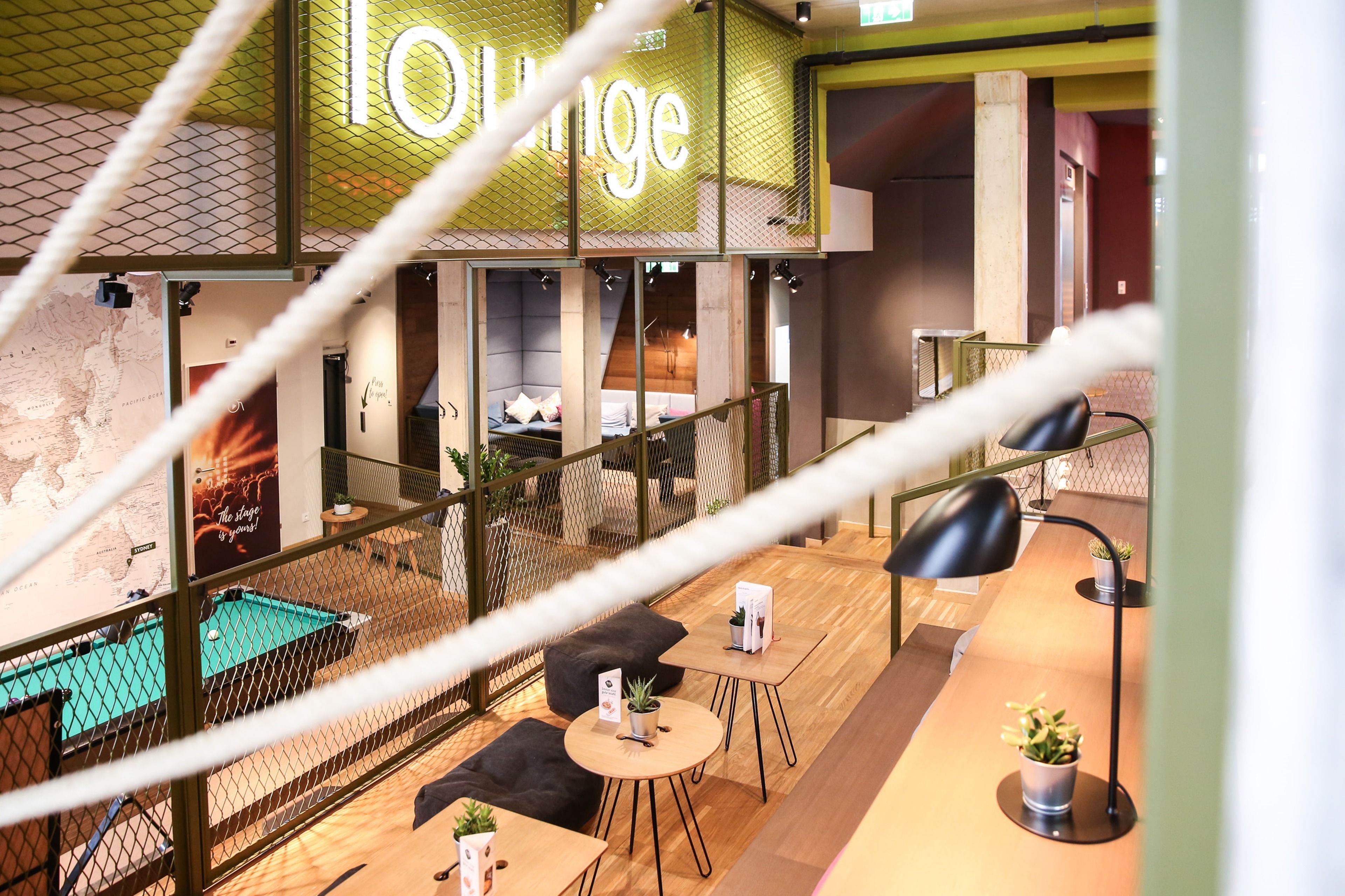 A lounge area with a pool table, seating, and a sign that reads "Lounge".