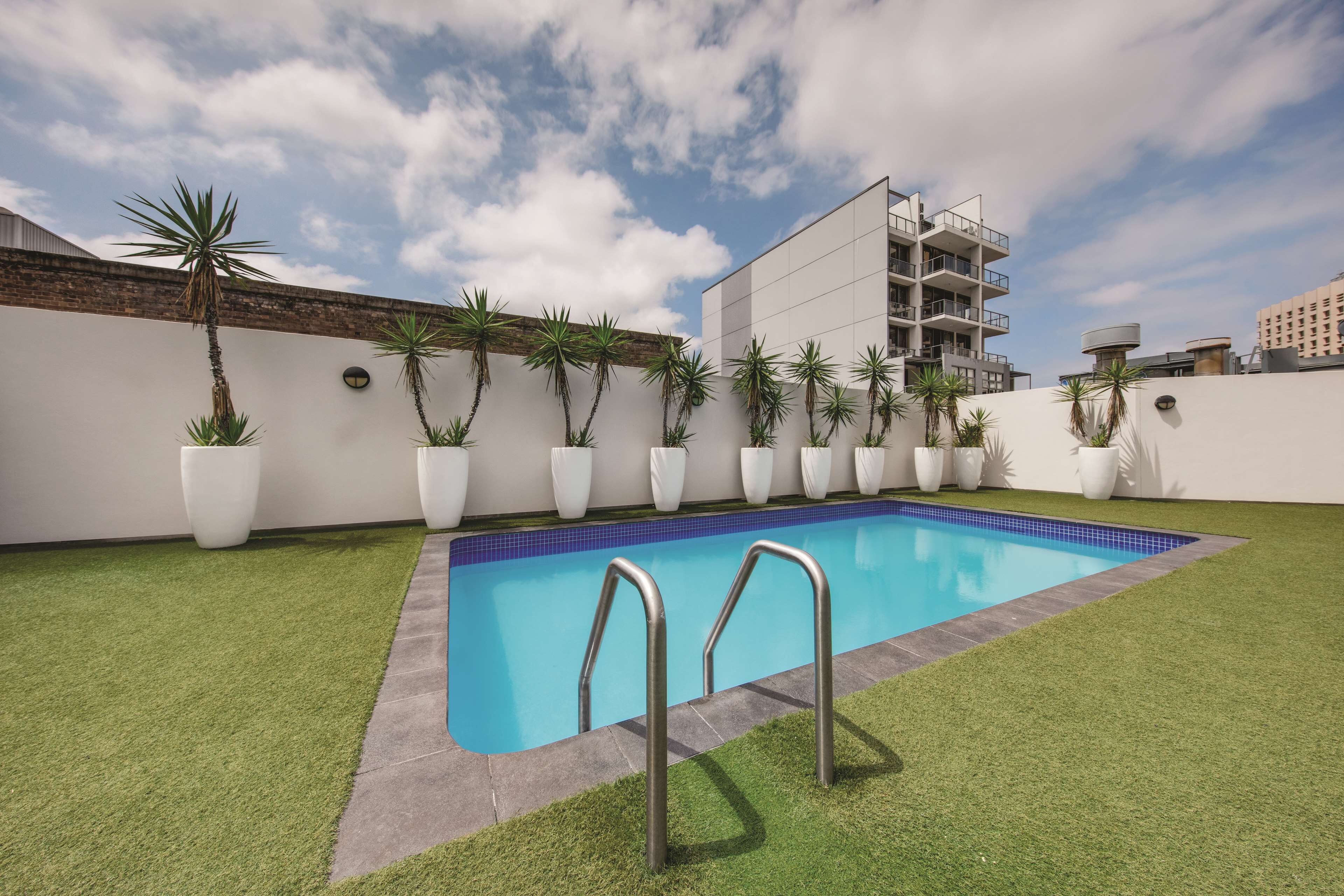 outdoor pool, open 6:00 am to 10:00 pm, pool umbrellas, pool loungers