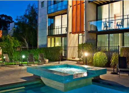Outdoor pool, pool umbrellas, pool loungers. Phillip Island Apartments