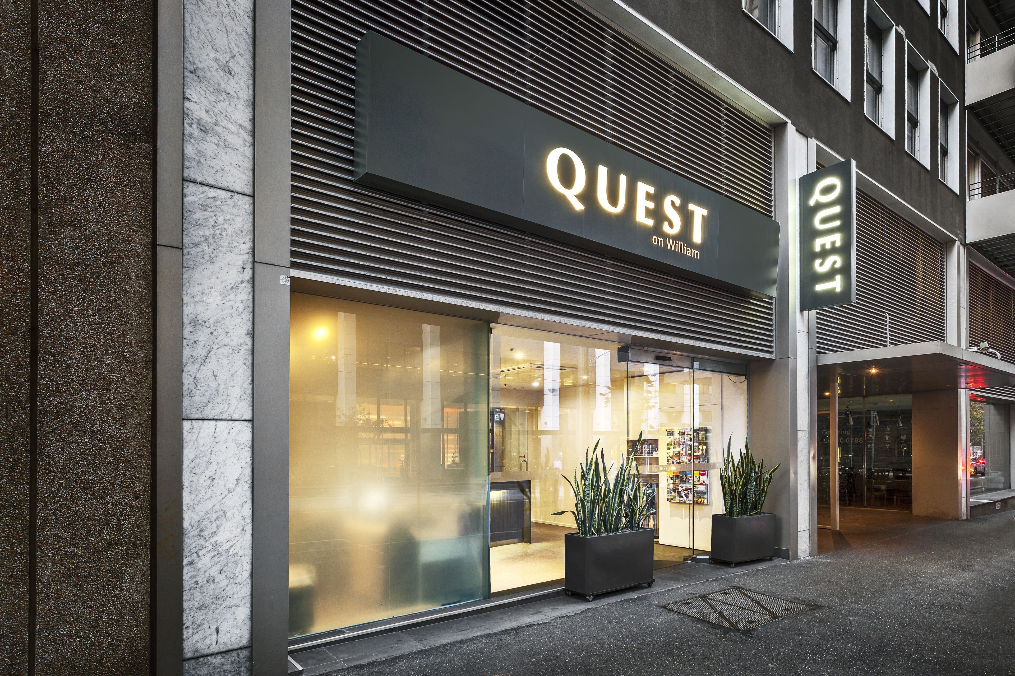 A modern building with a large glass entrance and the name "QUEST" prominently displayed above.