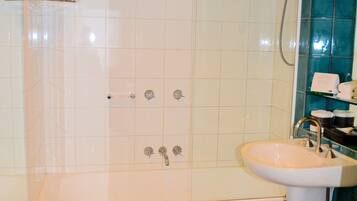 A bathroom with a bathtub, a sink, and a toilet.