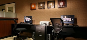 A hotel room with two desks, each with a computer and a 'Las Vegas' sign. There are two chairs, a printer, and a filing cabinet. - The Carriage House (Las Vegas)