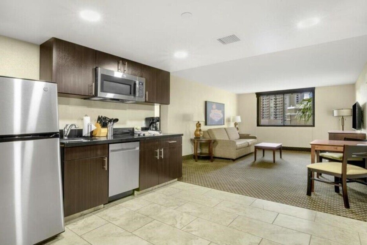 Suite, 1 King Bed | Living area | 32-inch flat-screen TV with satellite channels, TV, DVD player