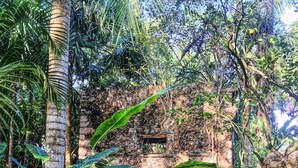 A rustic stone structure surrounded by lush tropical vegetation. - Hacienda Chichen Resort & Yaxkin Spa (Chichen Itza)