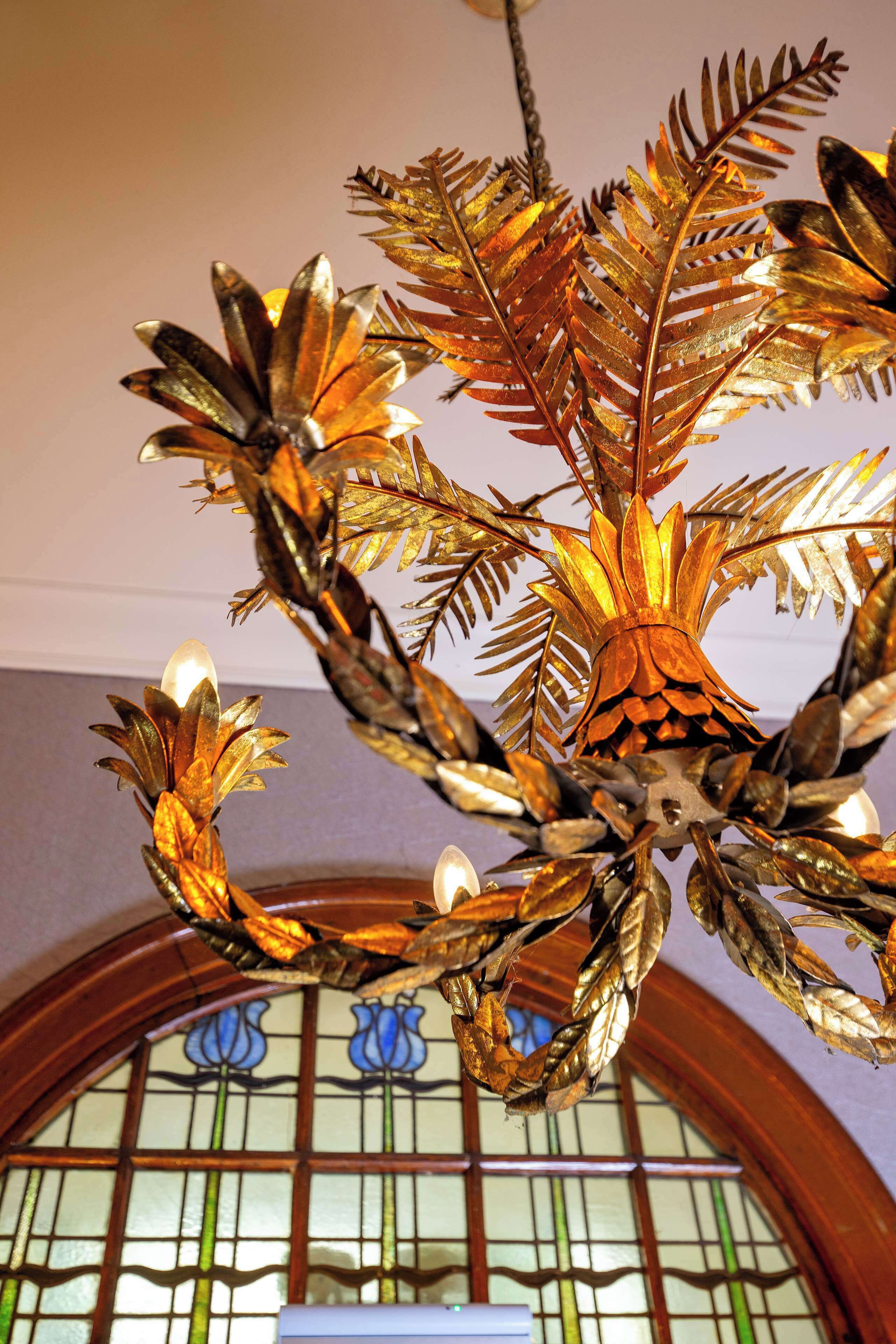 A chandelier with a pinecone and leaf design.
