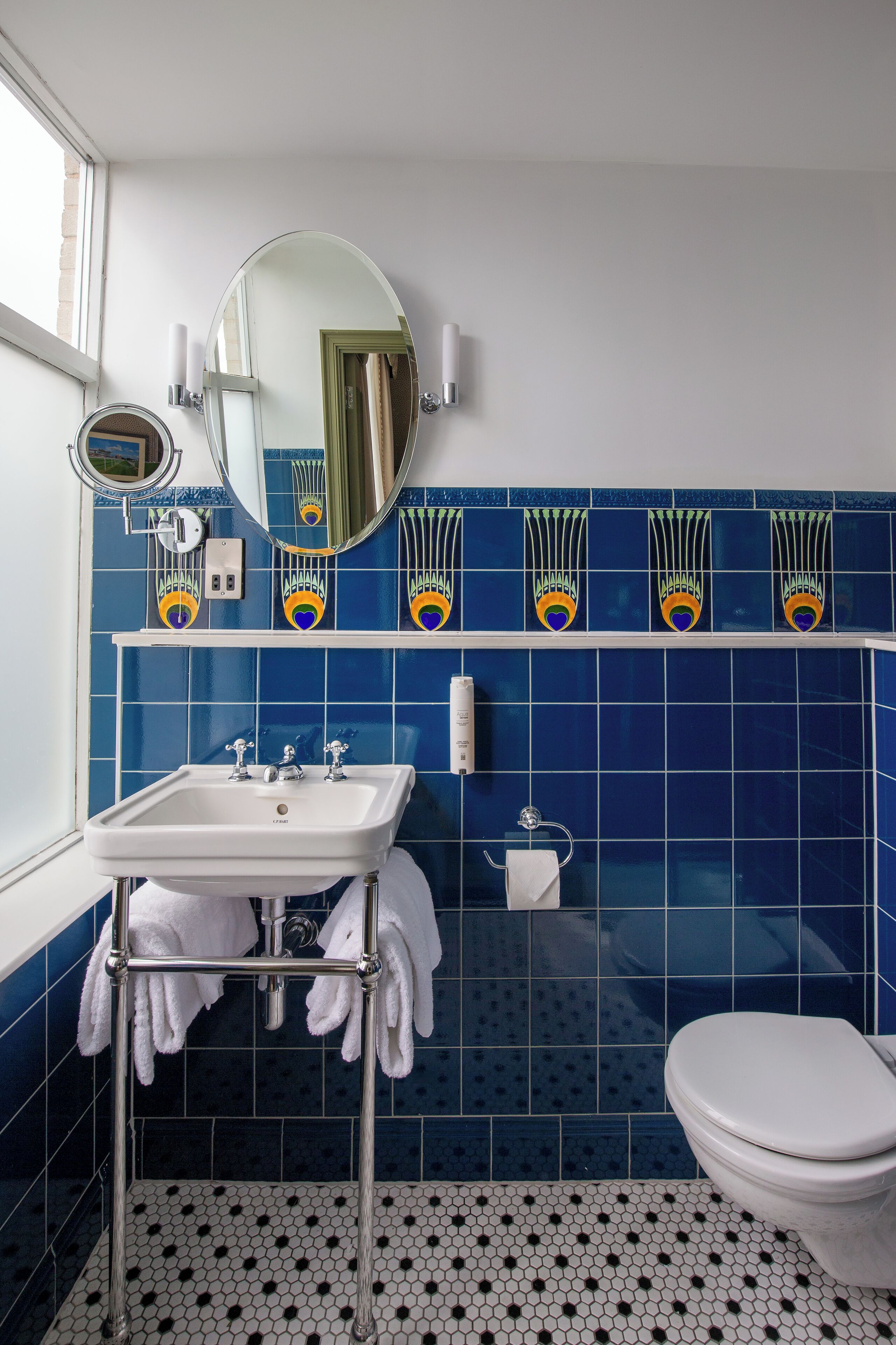 A bathroom with a white sink, a toilet, and a mirror.