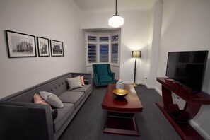 Apartment, Non Smoking, City View | Living area | Flat-screen TV