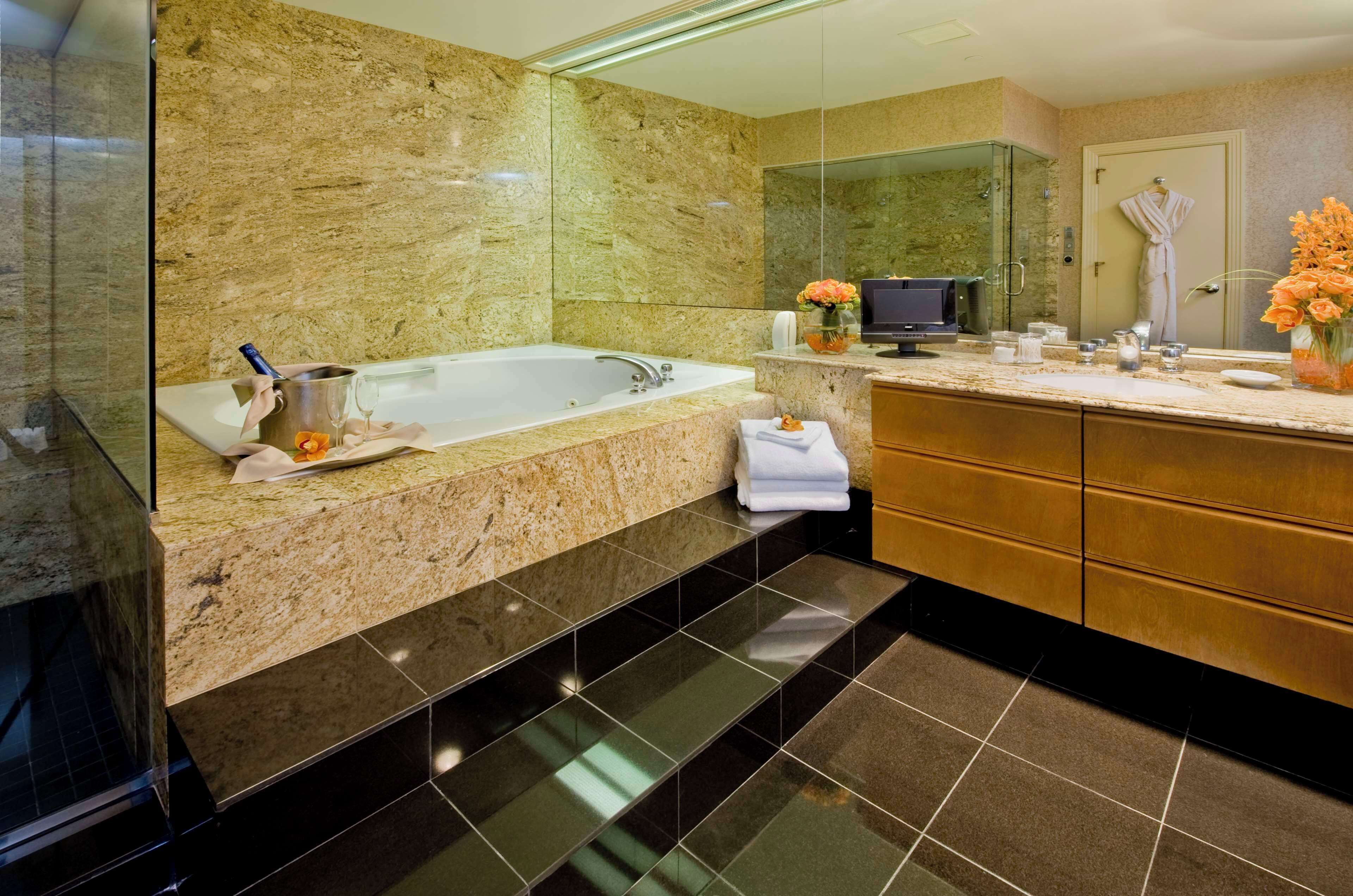 luxury penthouse, multiple beds | bathroom | designer toiletries, hair dryer, towels, soap
