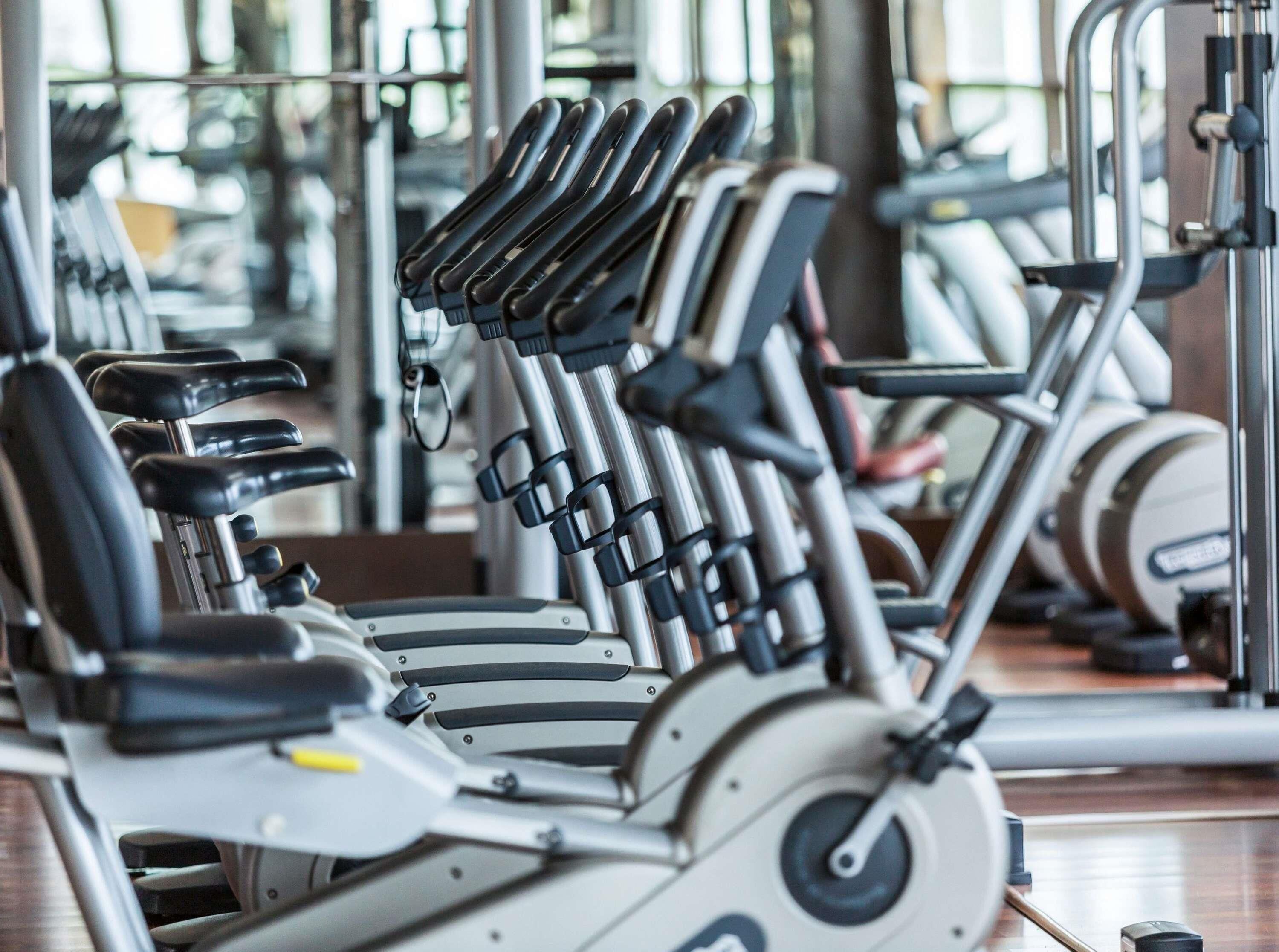 A gym with exercise equipment, including treadmills and weight machines.