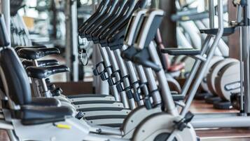 A gym with exercise equipment, including treadmills and weight machines.