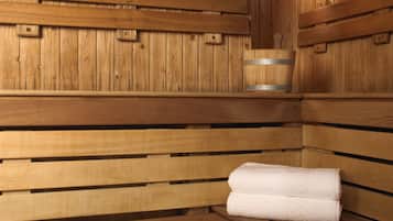 A wooden sauna with benches and a towel.