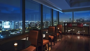 A high-rise interior with large windows offering a cityscape view at night. - Santiago Marriott Hotel (Santiago)