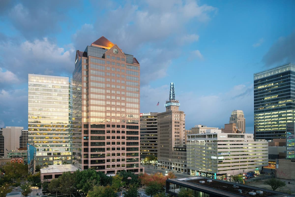 A cityscape with modern high-rise buildings, including a prominent bank and a building with a spire.