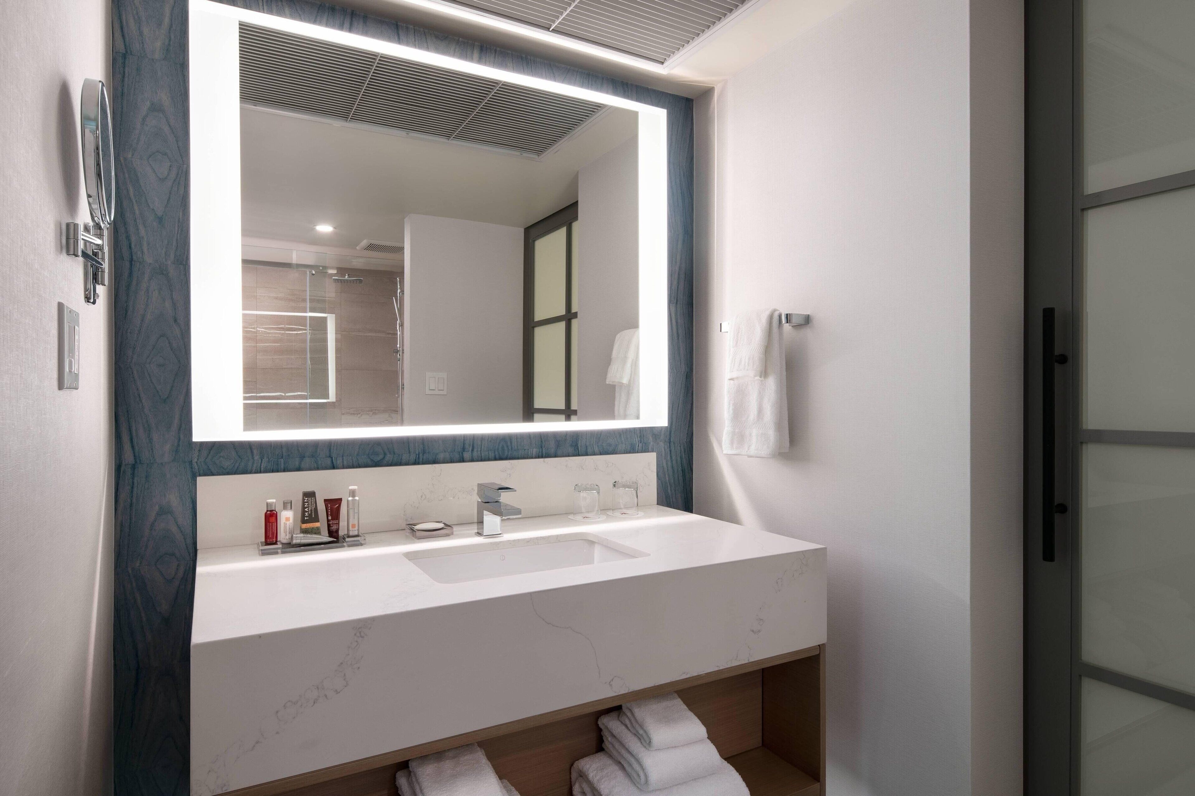 combined shower/bathtub, designer toiletries, hair dryer, towels