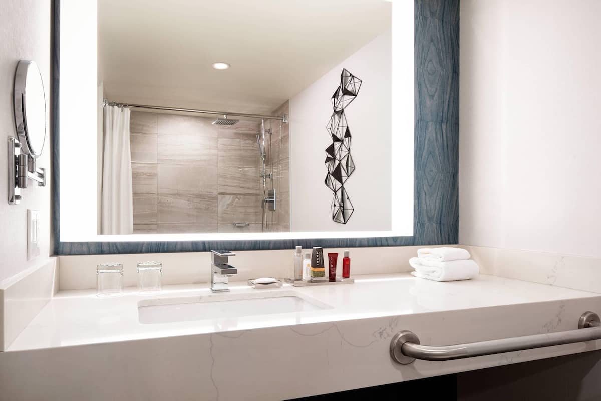 combined shower/bathtub, designer toiletries, hair dryer, towels