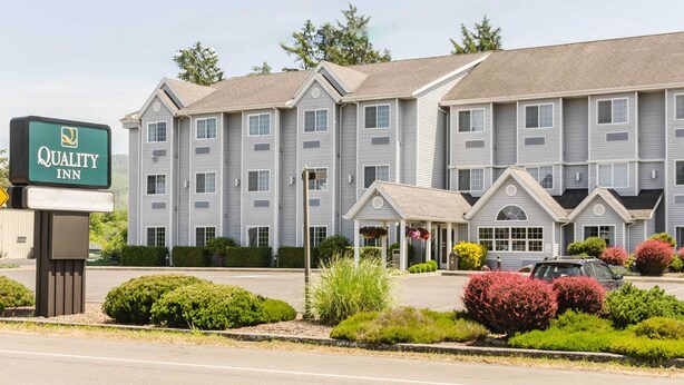 A Quality Inn hotel with a two-story building, a covered entrance, and a parking lot.