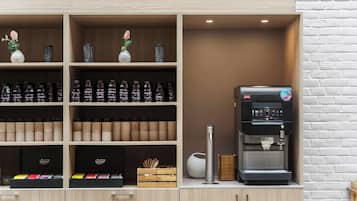 A coffee station with a coffee machine, shelves with coffee beans, and a vase with a rose.