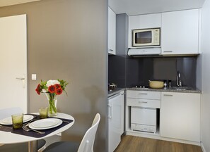 Enjoy meals in this kitchen with microwave and dining area for two.