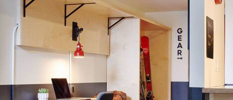 A compact room with a desk, chair, and a red carpeted area.