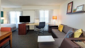A hotel room with a bed, desk, chair, sofa, and TV. - Residence Inn by Marriott Austin Parmer/Tech Ridge (Austin)