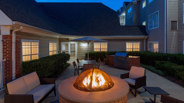 A patio with a fire pit, outdoor furniture, and a grill. - Residence Inn by Marriott Greenville-Spartanburg Airport (Greenville)