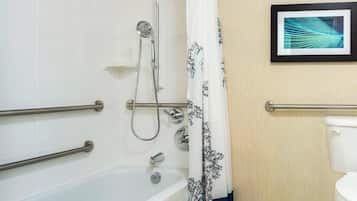 A bathroom with a bathtub, shower, and toilet.