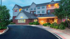 A Marriott Residence Inn with a brick facade, multiple windows, and a well-lit entrance. - Residence Inn By Marriott Louisville Northeast (Louisville)