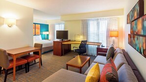 A hotel room with a bed, a desk with a computer, a television, a sofa, and a coffee table. - Residence Inn By Marriott Louisville Northeast (Louisville)