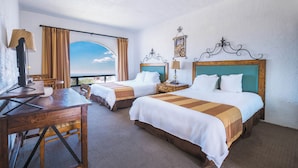 A hotel room with two beds, a desk, and a view of the sky. - Real del Mar Hotel & Golf Resort (Tijuana)