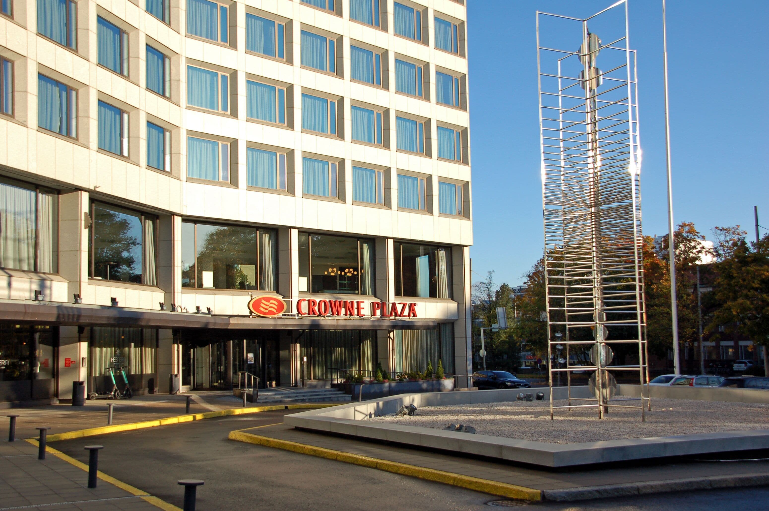 A modern building with a sign reading "CROWNE PLAZA".