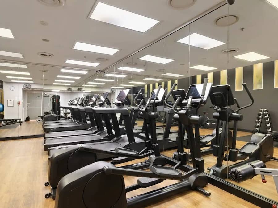 A gym with multiple treadmills, exercise balls, and weight machines.